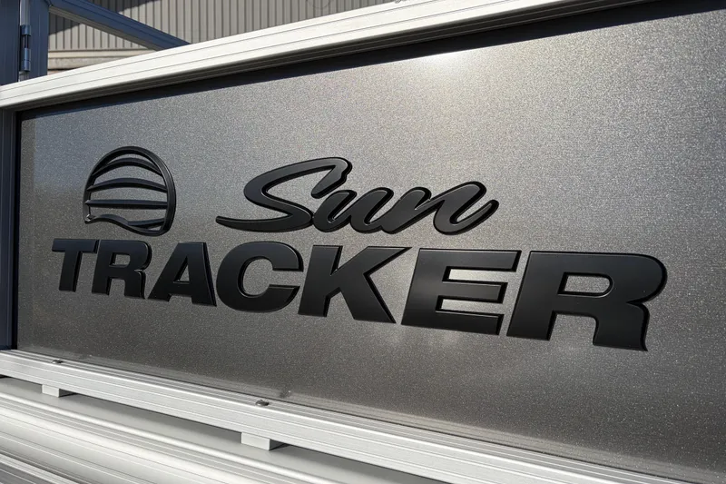 Slide: The Image of Sun Tracker Bass Buggy 18 DLX 2026 logo on metallic surface. - 15