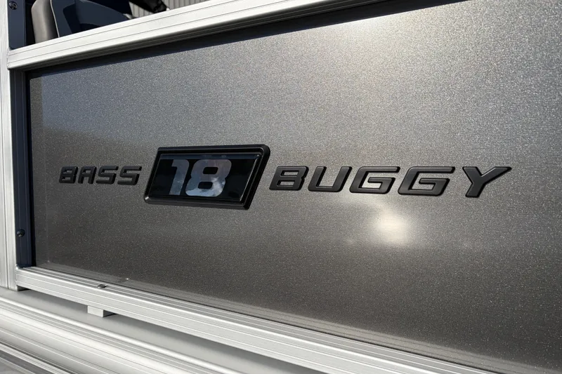 Slide: The Image of 2026 Sun Tracker Bass Buggy 18 DLX logo on metallic surface. - 16