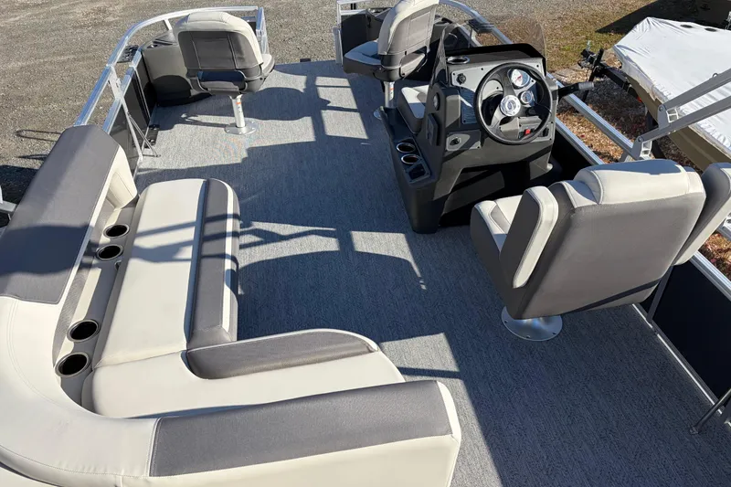 Slide: The Image of 2026 Sun Tracker Bass Buggy 18 DLX pontoon boat interior with seating and helm. - 21