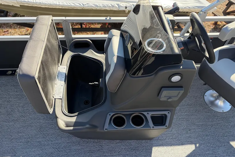 Slide: The Image of 2026 Sun Tracker Bass Buggy 18 DLX boat console with open storage compartment. - 23