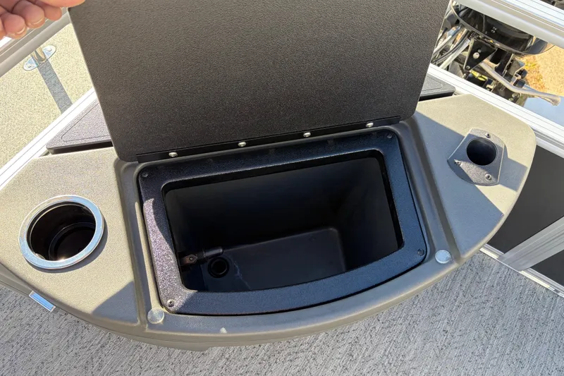 Slide: The Image of 2026 Sun Tracker Bass Buggy 18 DLX storage compartment with cup holders on deck. - 27