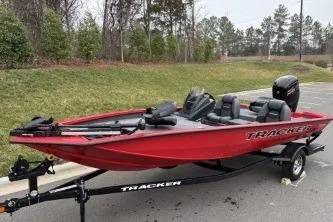 Slide: The Image of 2026 Tracker Pro Team 190 boat, red, on trailer, parked outdoors. - 4