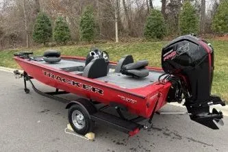 Slide: The Image of 2026 Tracker Pro Team 190 boat on trailer, red exterior, parked outdoors. - 5