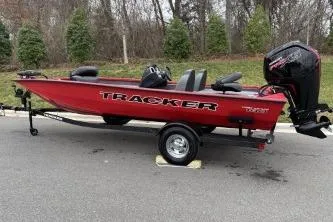 Slide: The Image of 2026 Tracker Pro Team 190 boat in red, parked on a trailer, outdoors. - 8