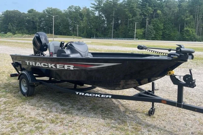 The Image of 2026 Tracker Super Guide V-16 SC boat on trailer, parked outdoors. - 0