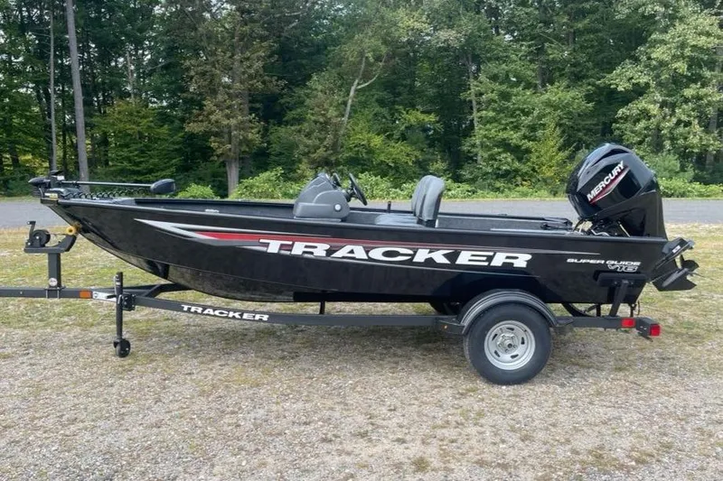 Slide: The Image of 2026 Tracker Super Guide V-16 SC boat on trailer, parked outdoors. - 2