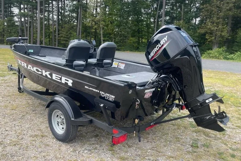 Slide: The Image of 2026 Tracker Super Guide V-16 SC boat with Mercury engine, parked on a trailer. - 4