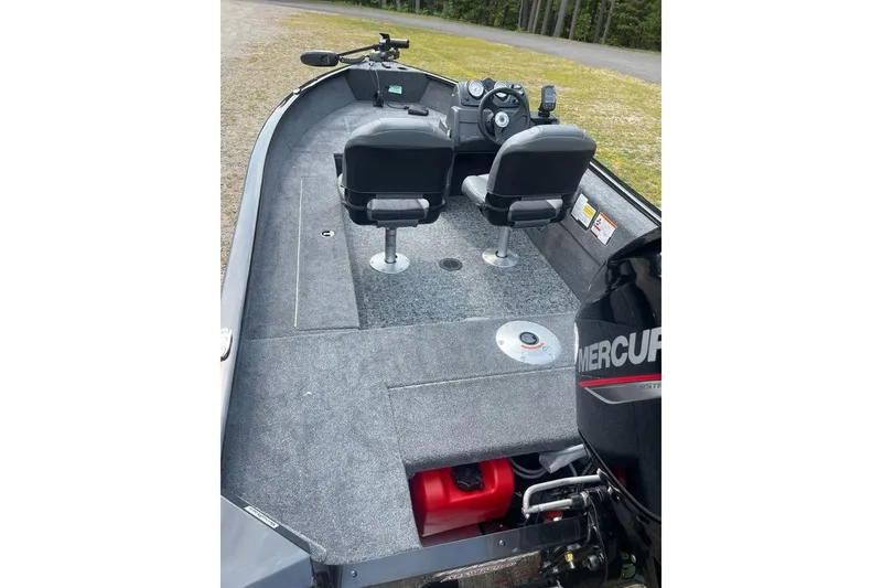 Slide: The Image of 2026 Tracker Super Guide V-16 SC boat interior with dual seats and Mercury engine. - 6