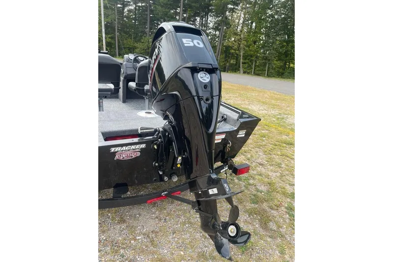 Slide: The Image of 2026 Tracker Super Guide V-16 SC boat with powerful outboard motor in a scenic outdoor setting. - 7