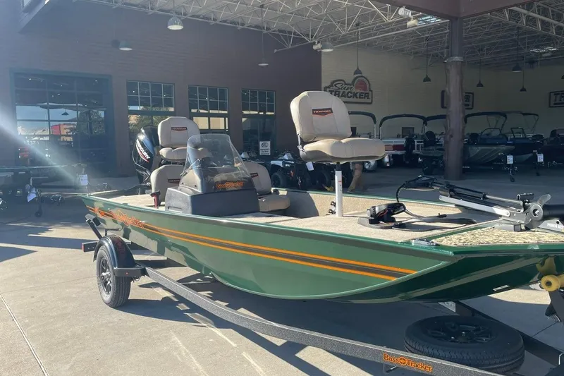 The Image of 2026 Tracker Bass Tracker Classic Limited boat in showroom, green exterior, equipped with fishing seats. - 0