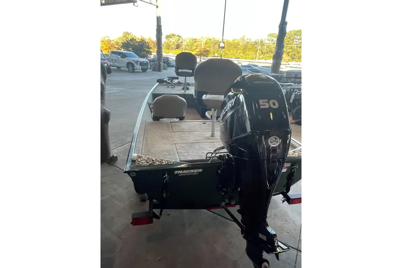 Slide: The Image of 2026 Tracker Bass Tracker Classic Limited boat with Mercury 150 engine in a showroom. - 3