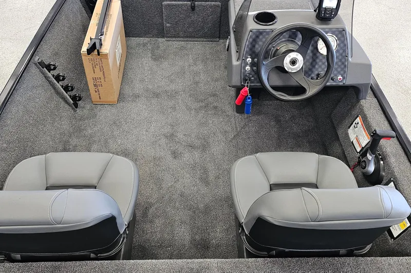Slide: The Image of 2026 Tracker Bass Tracker Classic XL boat interior with steering wheel and seats. - 10