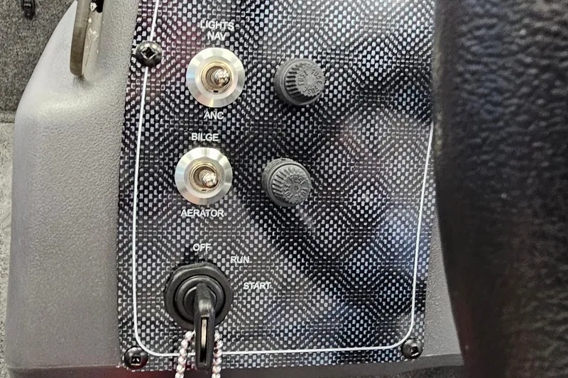 Slide: The Image of Control panel of 2026 Tracker Bass Tracker Classic XL boat with switches and ignition. - 14