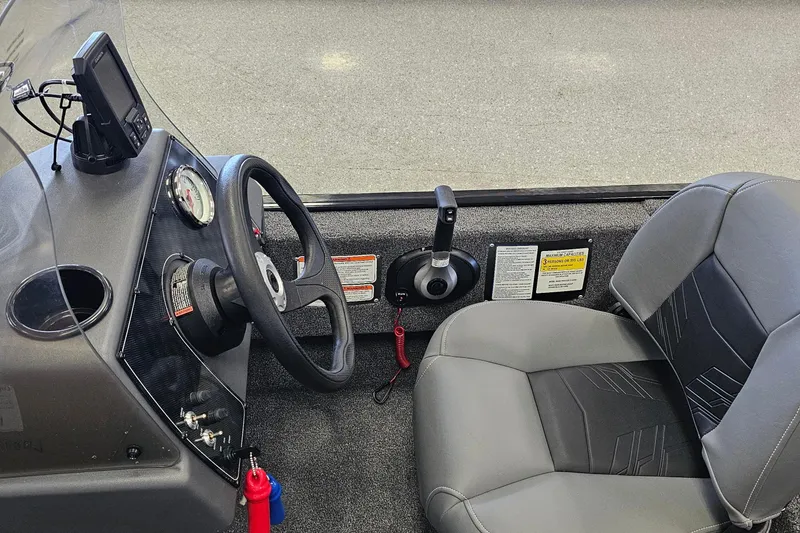 Slide: The Image of 2026 Tracker Bass Tracker Classic XL boat interior with steering wheel and seat. - 9