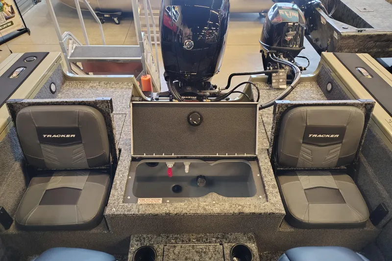 Slide: The Image of 2026 Tracker Targa V-18 Combo boat interior with seating and motor view. - 6