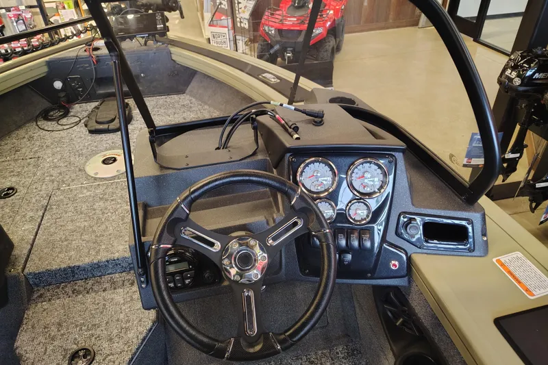 Slide: The Image of Interior view of 2026 Tracker Targa V-18 Combo boat dashboard with steering wheel and gauges. - 7