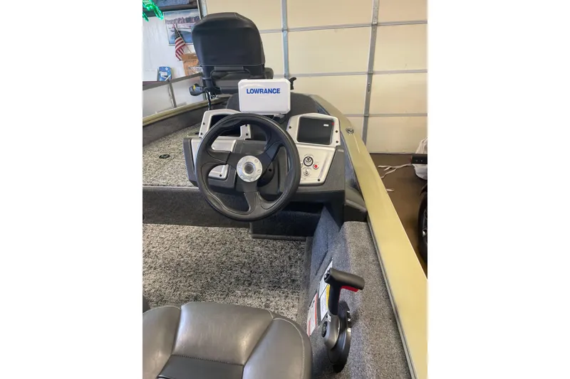 Slide: The Image of 2026 Tracker Pro Team 175 Crappie Edition boat interior with steering wheel and Lowrance system. - 3