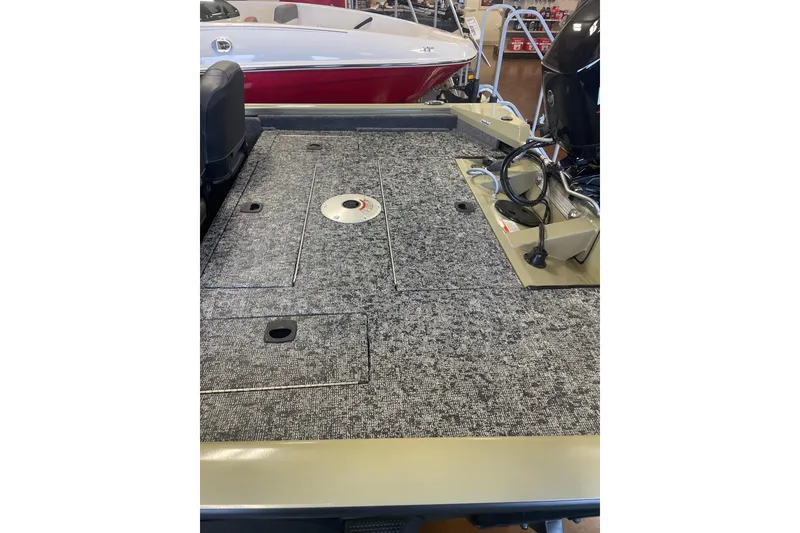 Slide: The Image of 2026 Tracker Pro Team 175 Crappie Edition boat interior with carpeted deck and motor. - 4