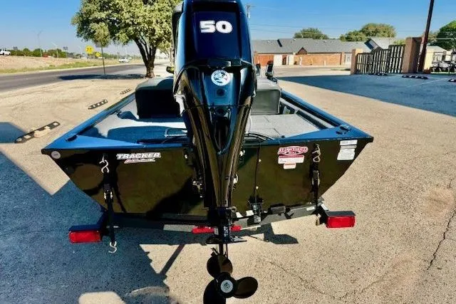 Slide: The Image of 2026 Tracker Pro 170 boat with a 50 HP motor, parked on a sunny street. - 3