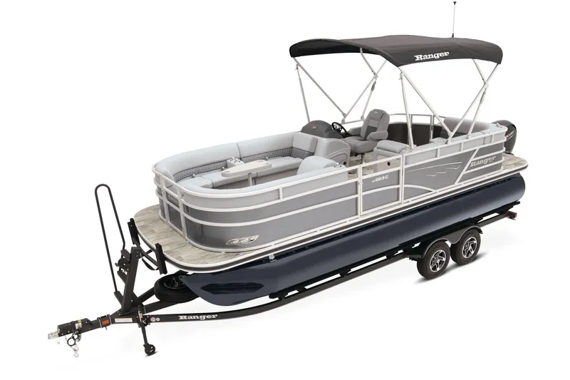 Slide: The Image of 2025 Ranger Reata 223C pontoon boat displayed at Tracker Boats dealership. - 2