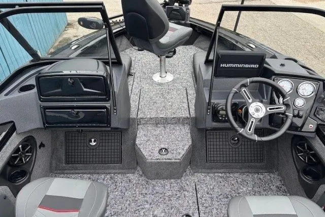 Slide: The Image of 2026 Tracker Targa V-19 Combo boat interior with steering wheel and seating. - 12