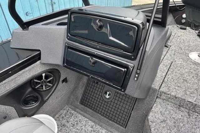 Slide: The Image of 2026 Tracker Targa V-19 Combo boat interior with storage compartments and speaker. - 14