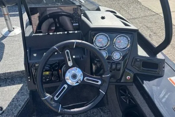 Slide: The Image of 2026 Tracker Targa V-19 Combo dashboard with steering wheel and instrument panel. - 16