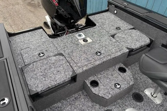 Slide: The Image of 2026 Tracker Targa V-19 Combo boat interior with gray carpeted deck and motor. - 23