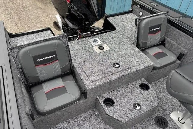 Slide: The Image of 2026 Tracker Targa V-19 Combo boat interior with gray seats and motor. - 25