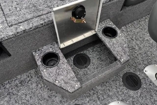 Slide: The Image of 2026 Tracker Targa V-19 Combo boat interior with cup holders and storage compartment. - 27