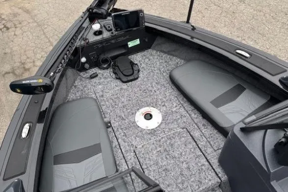 Slide: The Image of 2026 Tracker Targa V-19 Combo boat interior with gray seating and control panel. - 7