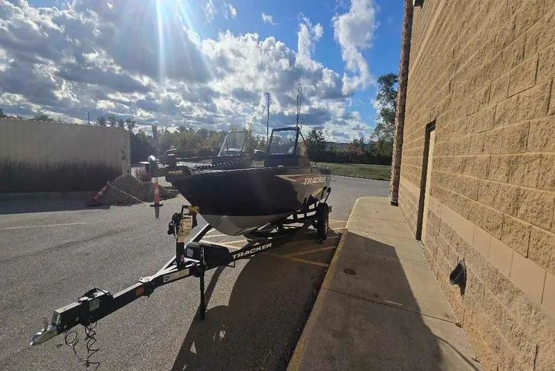 Slide: The Image of 2026 Tracker Pro Guide V-175 WT boat on trailer, parked outdoors under a sunny sky. - 72