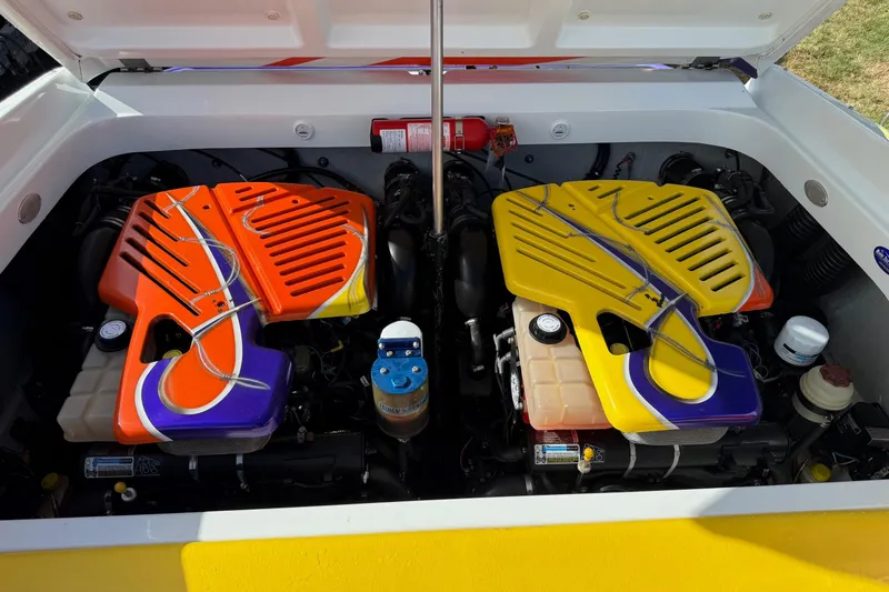 Slide: The Image of 2005 Baja 30 Outlaw boat engine compartment with vibrant orange and yellow covers. - 11