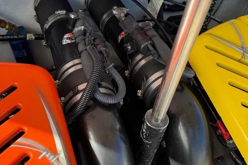 Slide: The Image of Engine components of a 2005 Baja 30 Outlaw boat with colorful covers. - 13