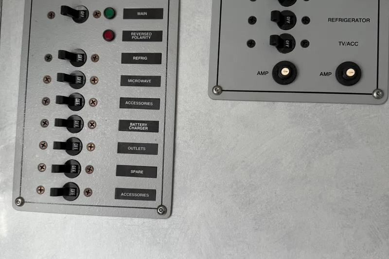 Slide: The Image of Electrical panel of a 2005 Baja 30 Outlaw boat with labeled switches and controls. - 15