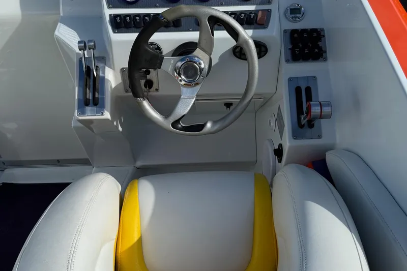 Slide: The Image of 2005 Baja 30 Outlaw boat cockpit with steering wheel and controls. - 20