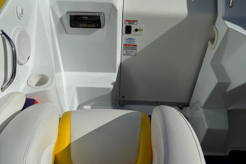 Slide: The Image of 2005 Baja 30 Outlaw boat interior with white and yellow seating, stereo system, and cup holder. - 21
