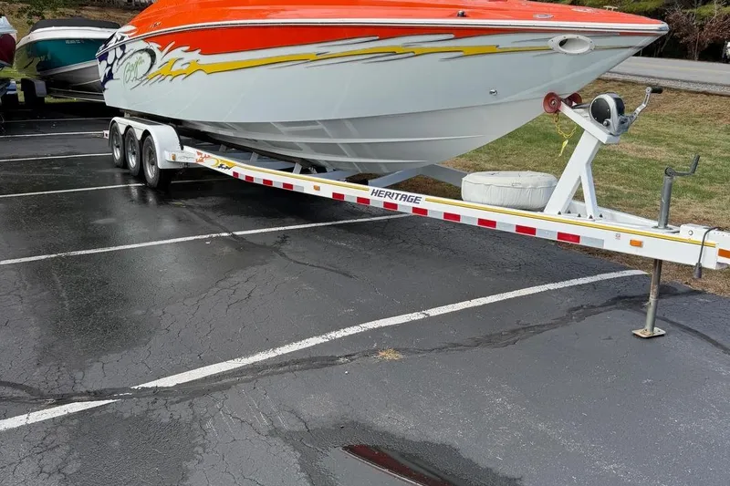 Slide: The Image of 2005 Baja 30 Outlaw boat on a trailer in a parking lot. - 3