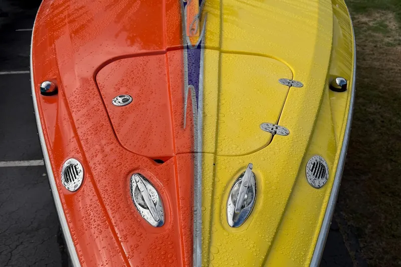 Slide: The Image of 2005 Baja 30 Outlaw boat with vibrant orange and yellow hull, covered in water droplets. - 8