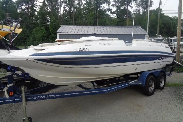 The Image of 2000 Harris-Kayot 226 Super Deck boat on trailer, parked outdoors. - 0