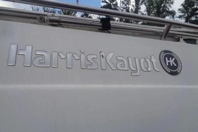 Slide: The Image of Harris-Kayot 226 Super Deck 2000 boat logo with trees in the background. - 2