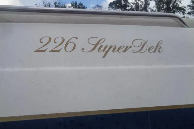 Slide: The Image of 2000 Harris-Kayot 226 Super Deck boat with gold lettering on the side. - 8