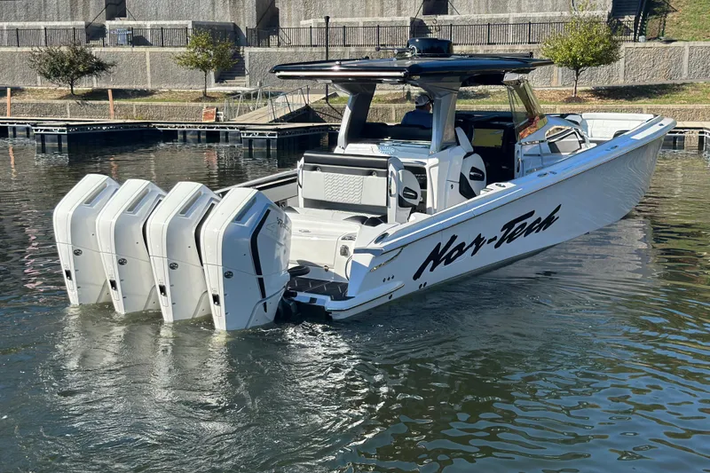 Slide: The Image of 2025 Nor-Tech 450 Sport Center Console boat with four powerful engines on the water. - 19