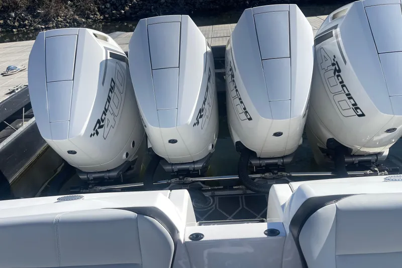 Slide: The Image of Four powerful outboard engines on a 2025 Nor-Tech 450 Sport Center Console boat. - 21
