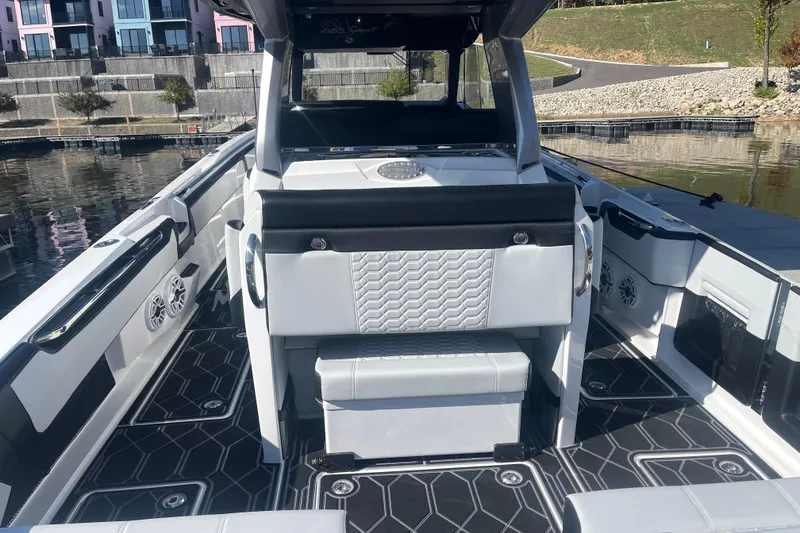 Slide: The Image of 2025 Nor-Tech 450 Sport Center Console boat interior with modern seating and sleek design. - 22