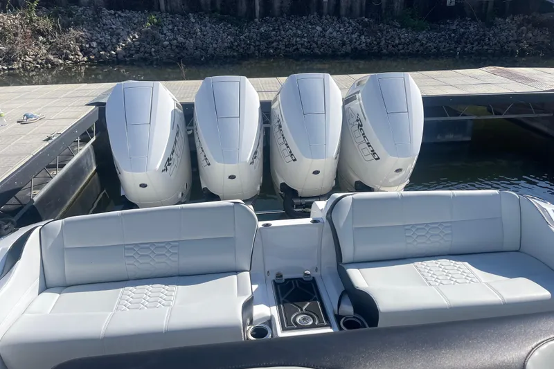 Slide: The Image of 2025 Nor-Tech 450 Sport Center Console with four powerful outboard engines docked. - 24