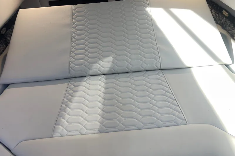 Slide: The Image of 2025 Nor-Tech 450 Sport Center Console, white cushioned seating with hexagonal pattern design. - 41