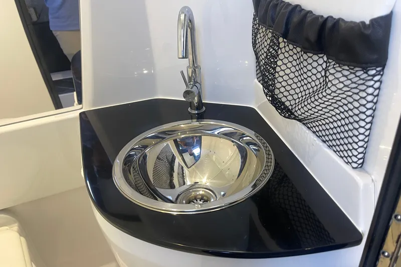 Slide: The Image of 2025 Nor-Tech 450 Sport Center Console sink with sleek faucet and netted storage. - 43