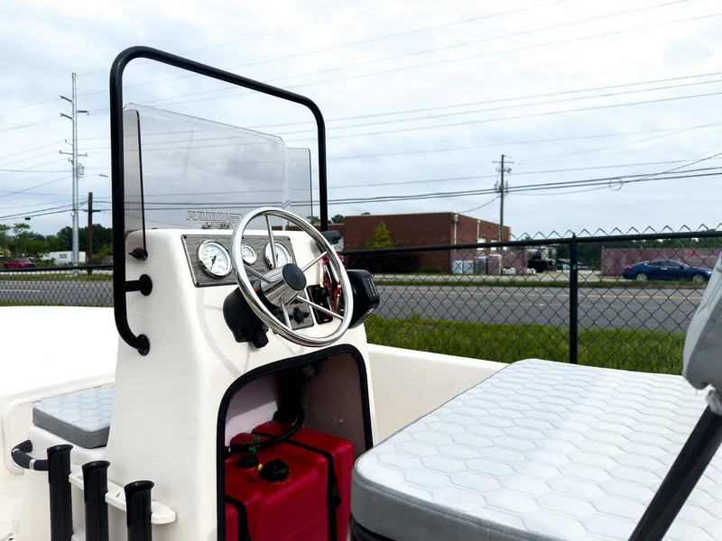 Slide: The Image of 2025 Carolina Skiff 16 JVX CC boat interior with steering console and seating. - 3