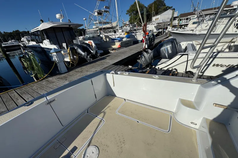 Slide: The Image of 1986 Luhrs Tournament 290 boat docked at marina with Yamaha outboard motor. - 13